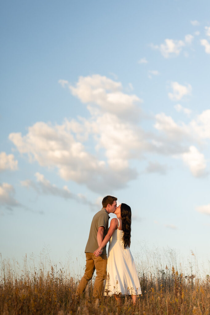 playful and romantic engagement photos in a golden field in bemidji mn