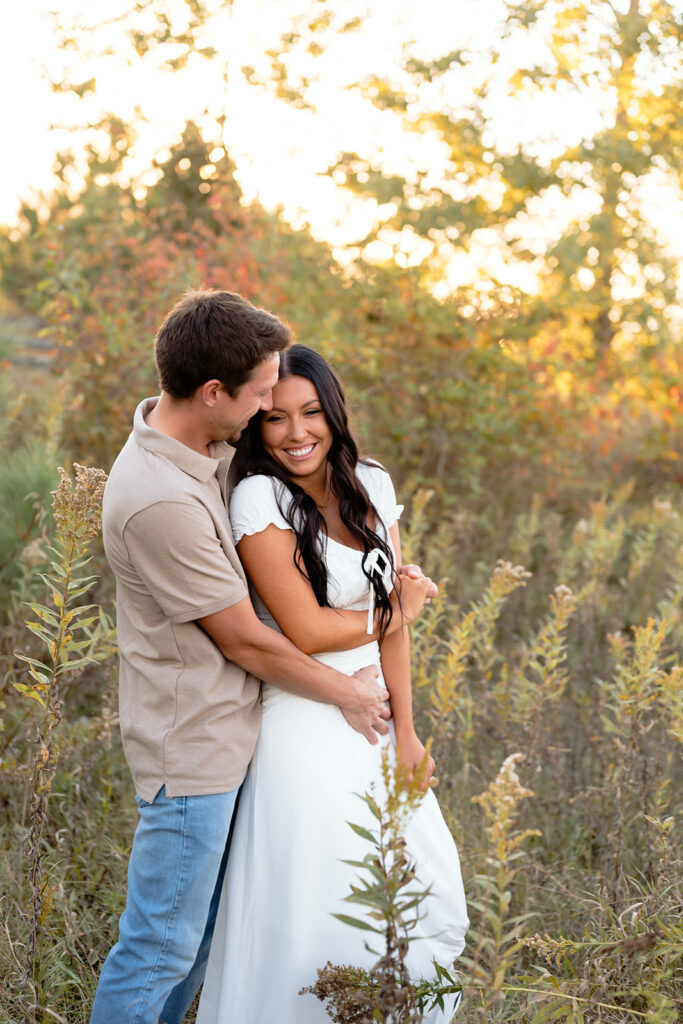 playful and romantic engagement photos in a golden field in bemidji mn