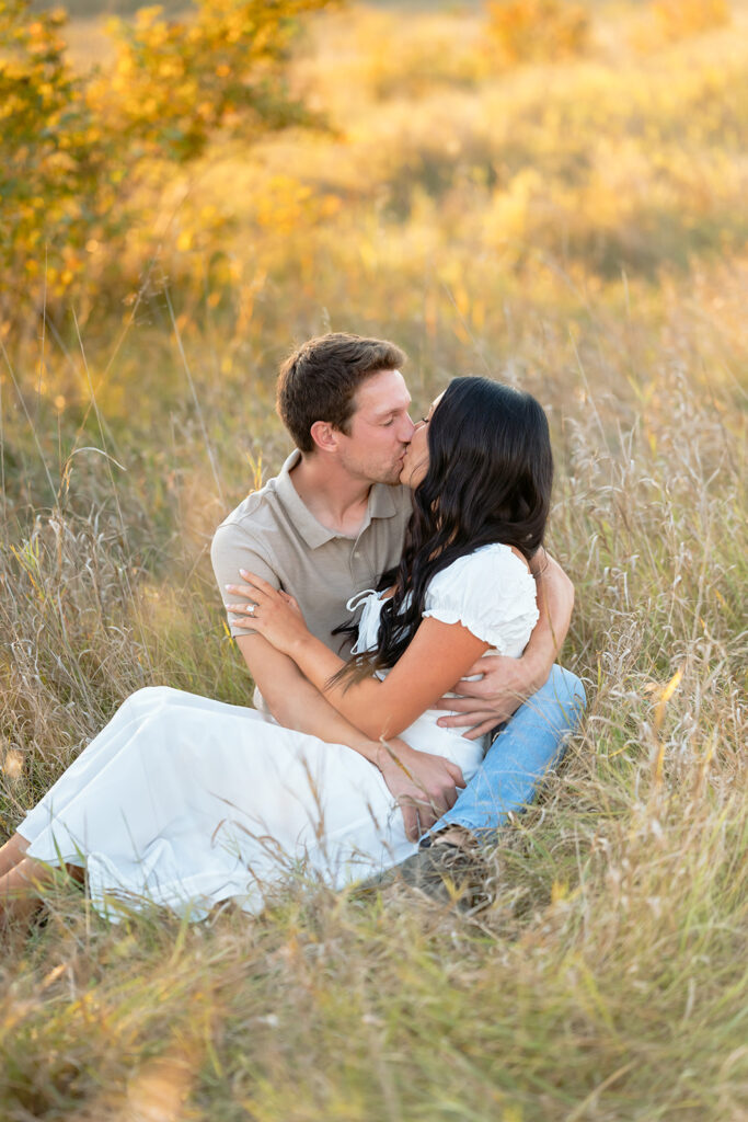 playful and romantic engagement photos in a golden field in bemidji mn