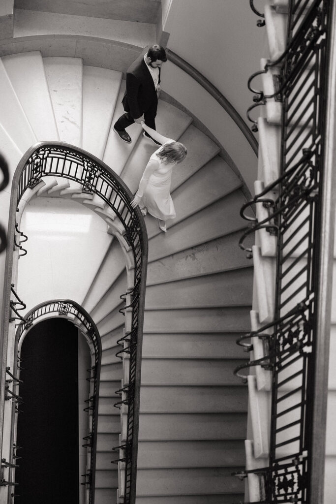 candid engagement photos on the grand staircase inside the Minnesota State Capitol