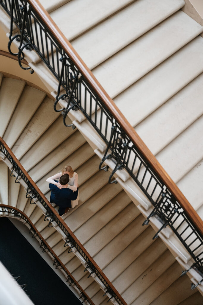 candid engagement photos on the grand staircase inside the Minnesota State Capitol