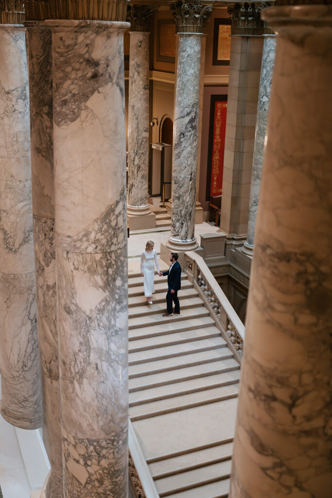 candid engagement photos on the grand staircase inside the Minnesota State Capitol