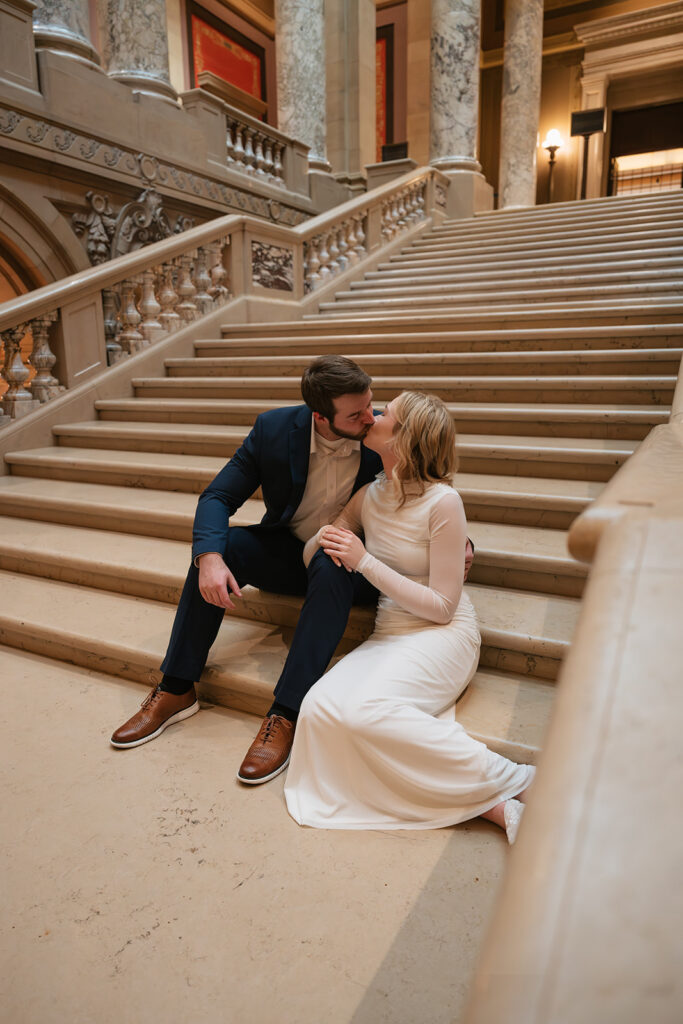 candid engagement photos on the grand staircase inside the Minnesota State Capitol