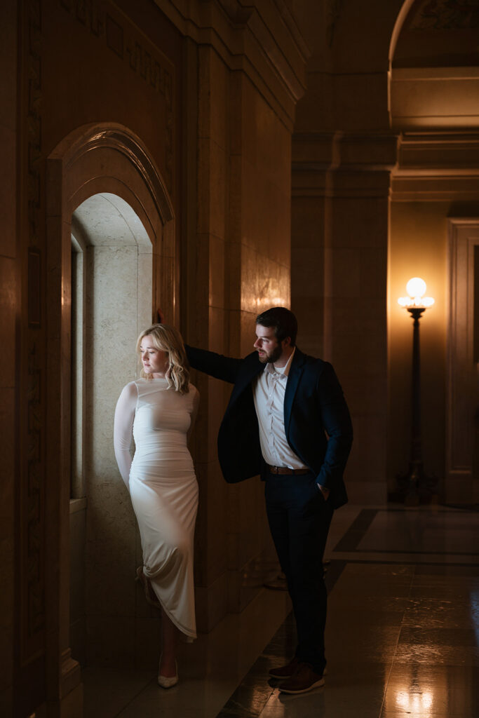 moody engagement portraits with natural window light at the Minnesota State Capitol