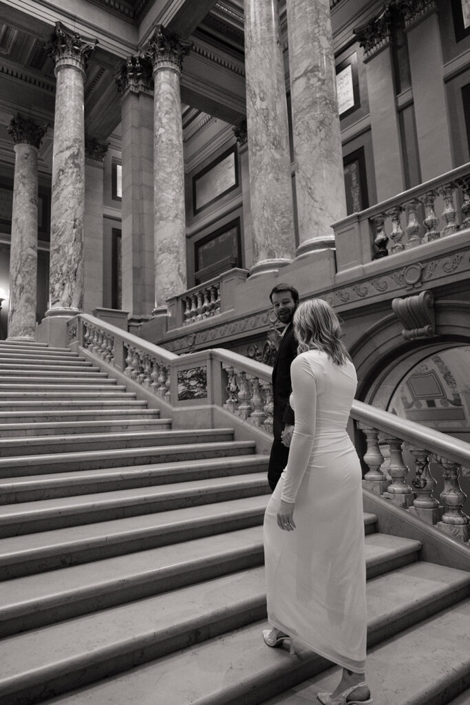 candid engagement photos on the grand staircase inside the Minnesota State Capitol