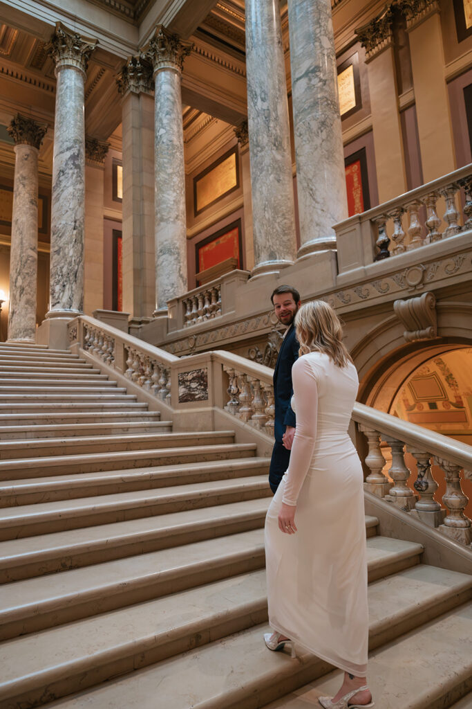 candid engagement photos on the grand staircase inside the Minnesota State Capitol