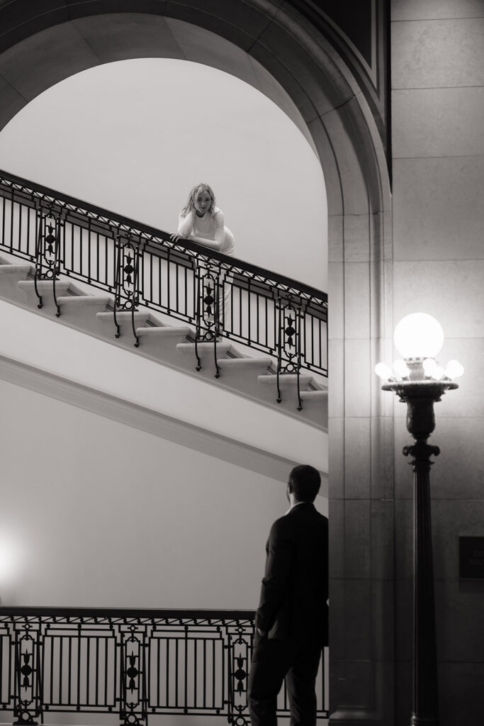 candid engagement photos on the grand staircase inside the Minnesota State Capitol