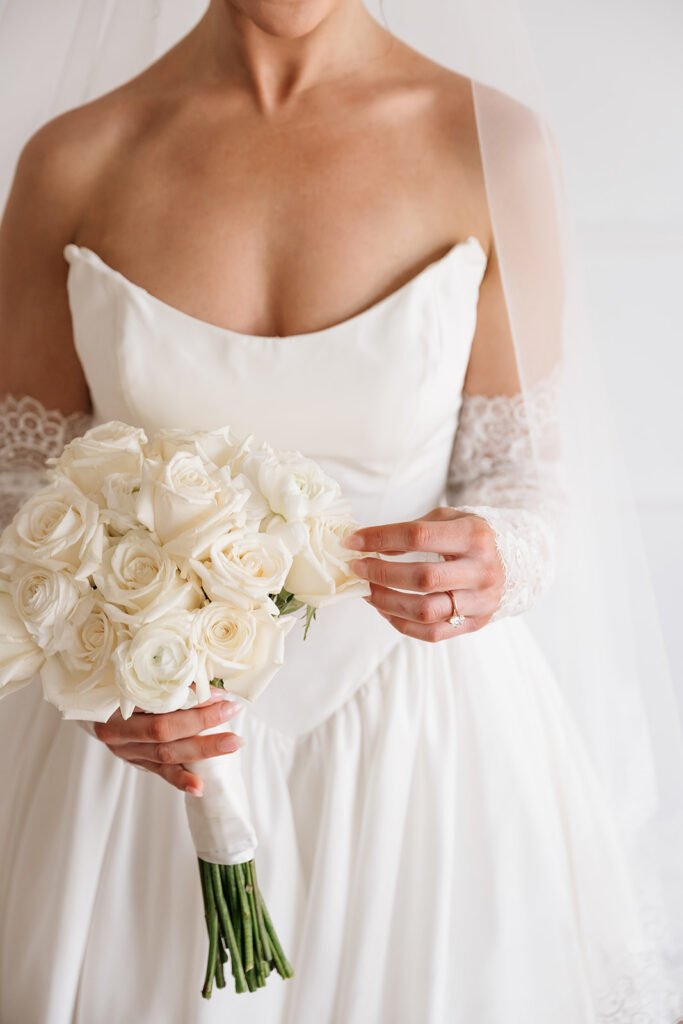 detail photo of bride’s lace gloves and wedding rings during studio wedding session in Bemidji MN