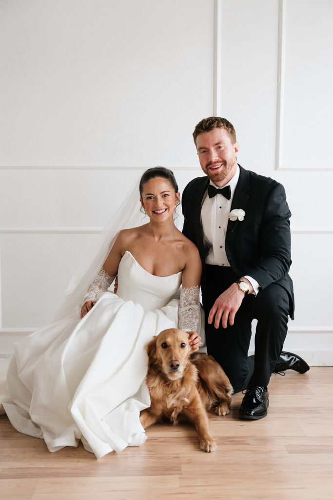 bride and groom with golden retriever during elegant studio wedding photos in Bemidji MN