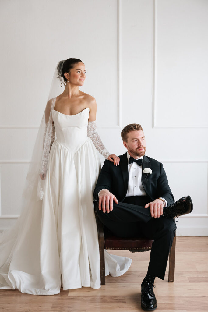 elegant bride standing beside groom in tuxedo for studio wedding photos in Bemidji MN