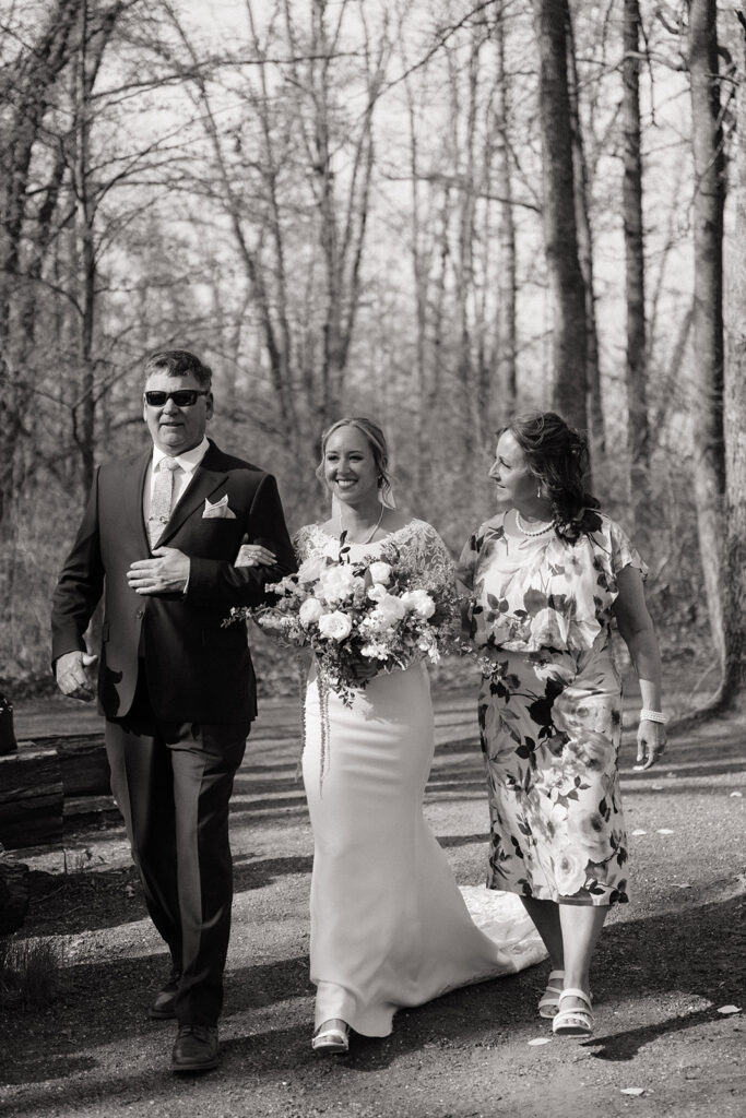 bride walking down the aisle with mom and dad
