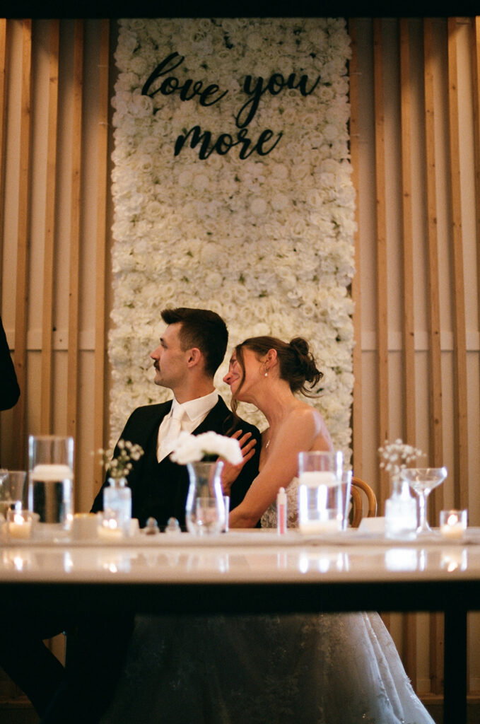 candid bride and groom reactions during wedding speeches