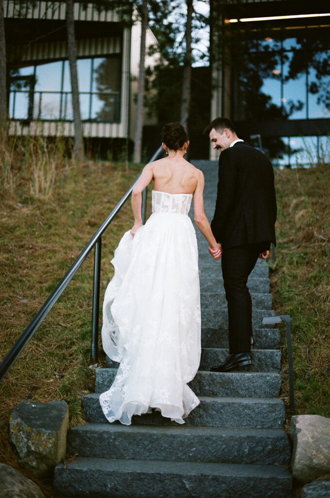 bride and groom walking up the steps at the catalyst by nature link