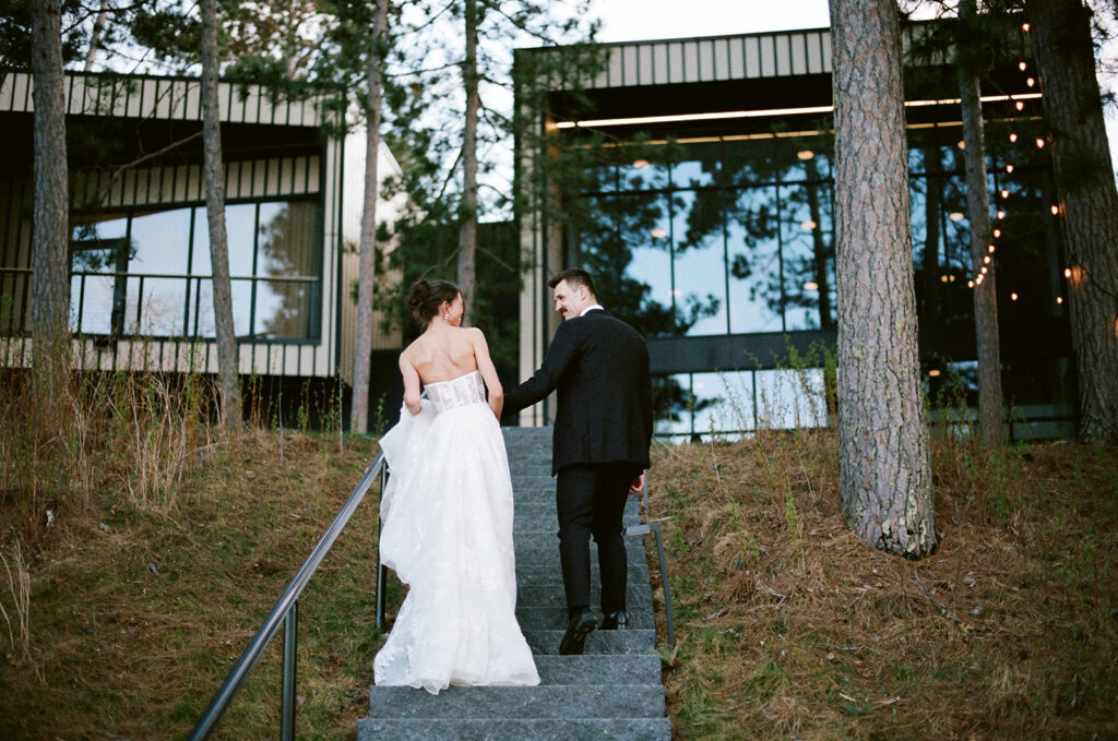 bride and groom walking up the steps at the catalyst by nature link