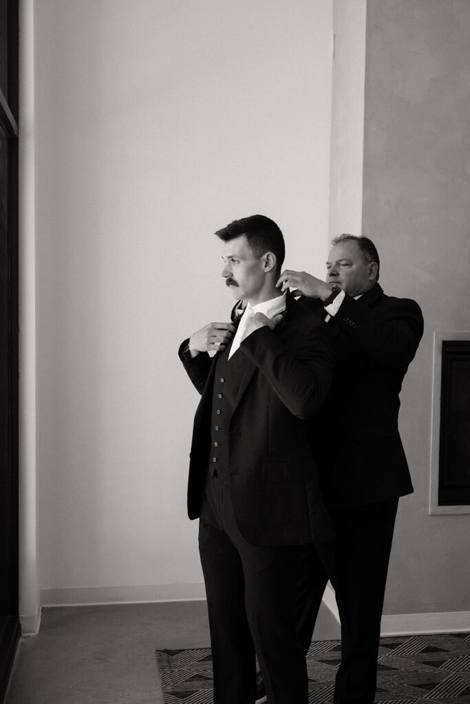 groom getting ready with his dad
