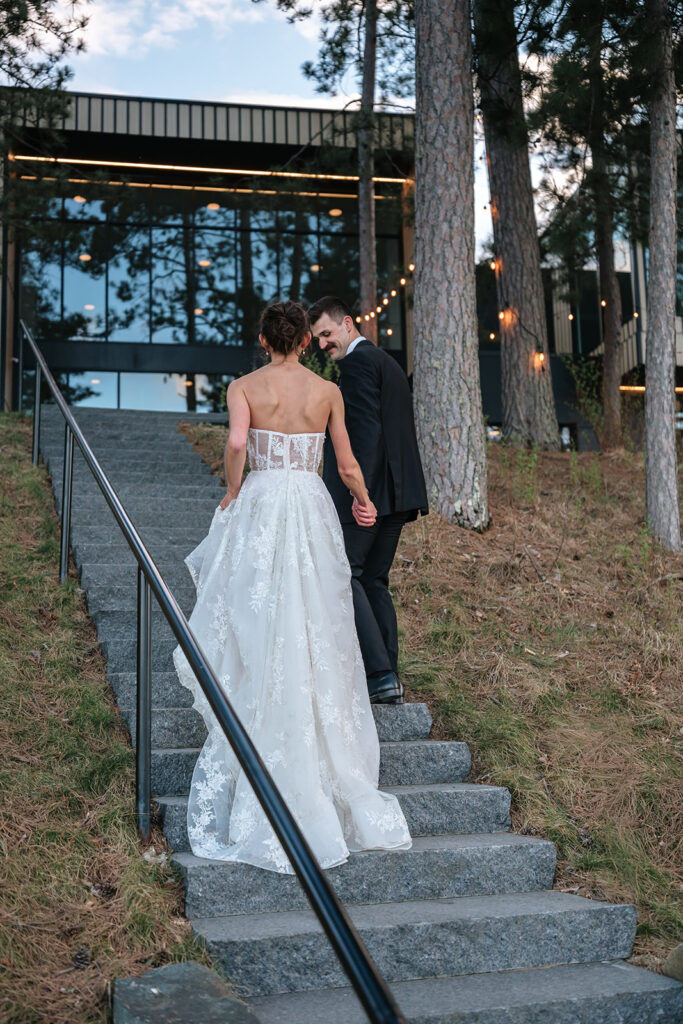 bride and groom walking up the steps at the catalyst by nature link