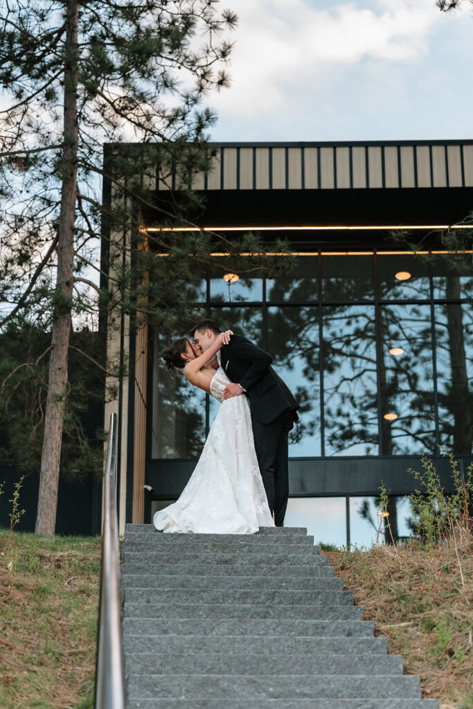bride and groom up the steps at the catalyst by nature link