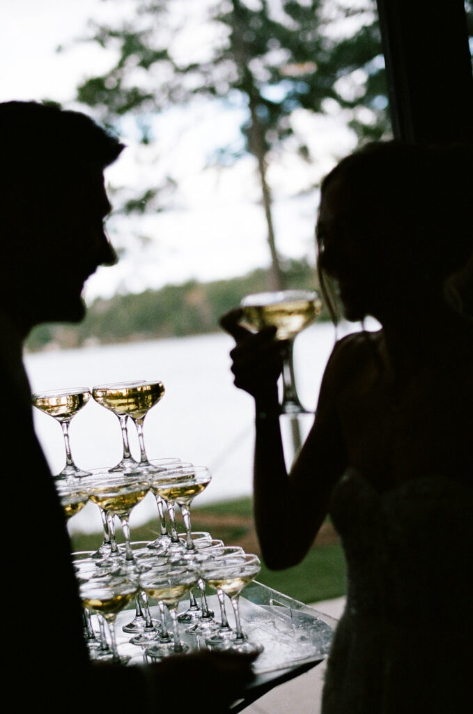 bride and groom drinking from the champagne tower