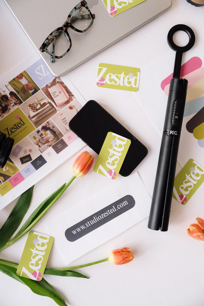 Flat lay of branded stationery, laptop, camera, phone, tulips and content creation tools at The Sunroom Studio.