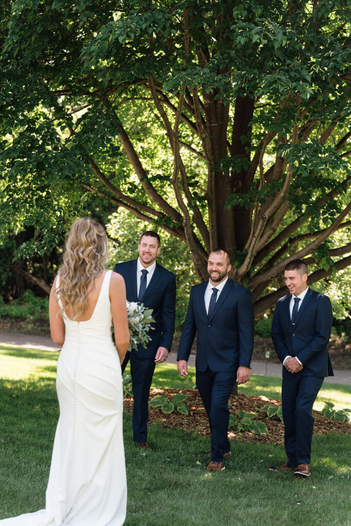 bride and groomsmen first look
