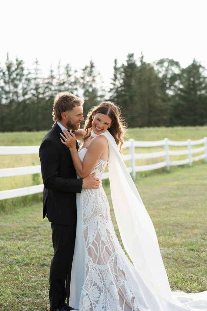 bride and groom in the lush fields at bluebelle event venue in bemidji, mn