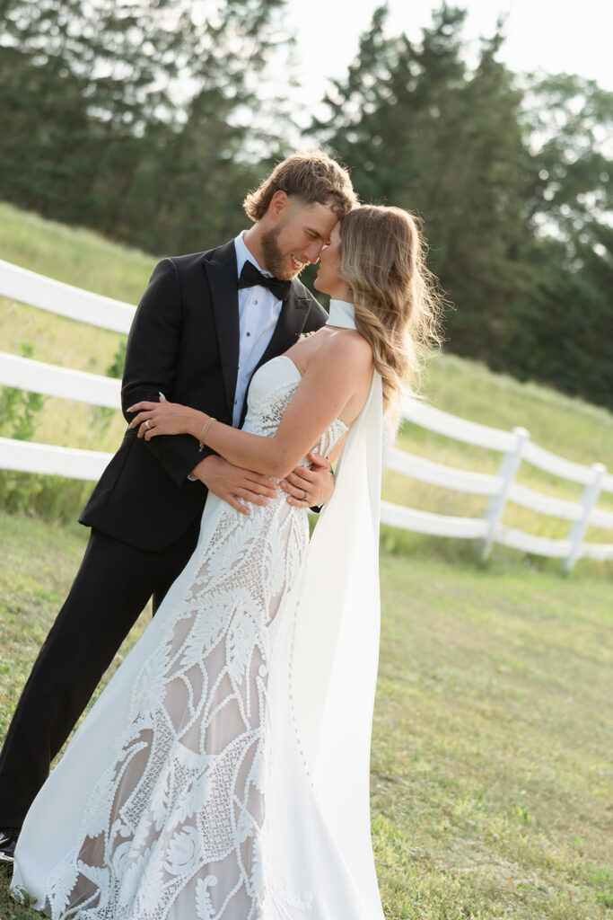 bride and groom in the lush fields at bluebelle event venue in bemidji, mn