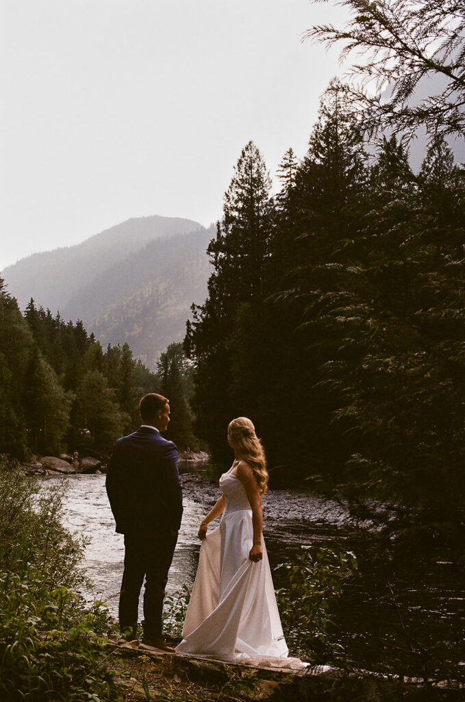 bride and groom at glacier national park with mountain views in the backdrop