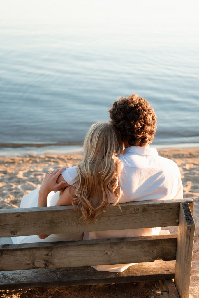 playful couple at the beach of lake bemidji during sunset