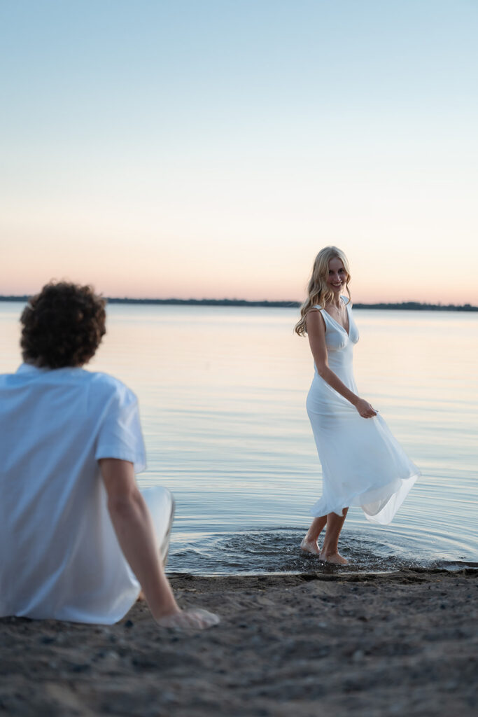 playful couple at the beach of lake bemidji
