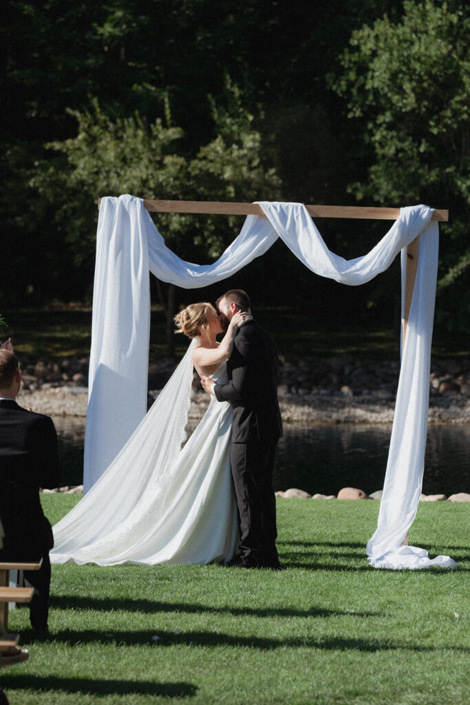 bride and groom first kiss at the ceremony